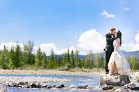 Bride and groom kissing in the rocky mountains